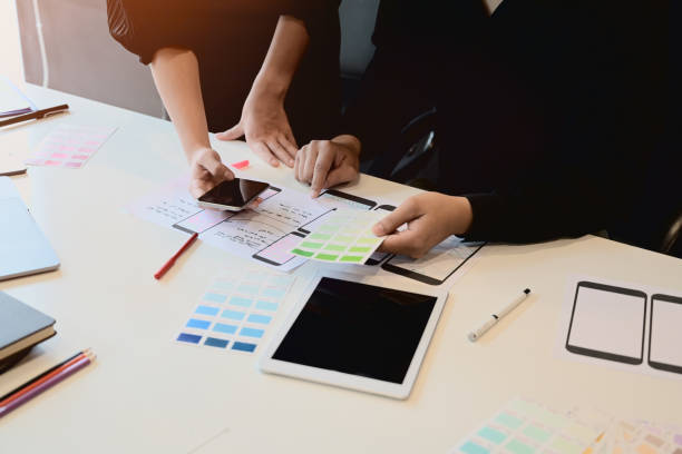 istock UI UX designer sketching layout design  application on mockup mobile phone. 1050511196