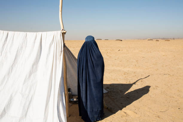 A woman and  refugee camp
