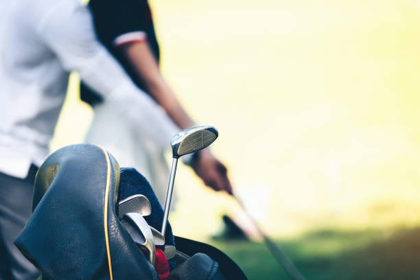 istock Midsection Of Couple Playing Golf At Sunset 1050540042