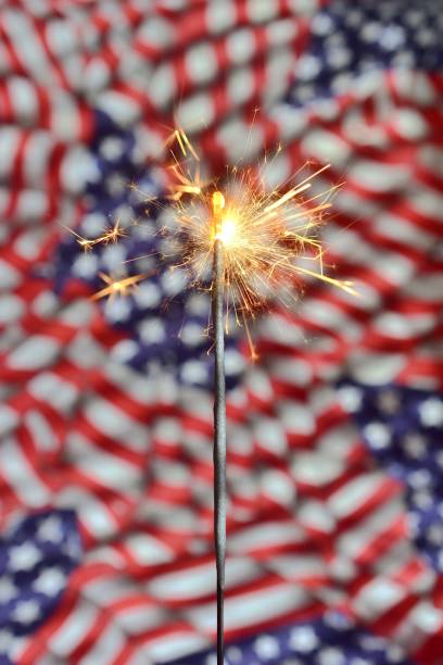 istock High Angle View Of Sparklers Burning Over Flag 1050543362