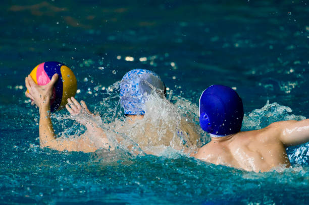istock People Playing With Ball While Swimming In Pool 1050548498