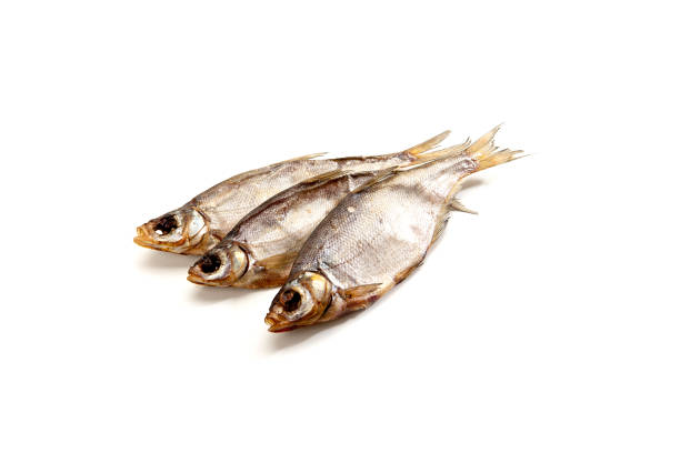 istock Dried salted fish sticks isolated on white. 1050550724