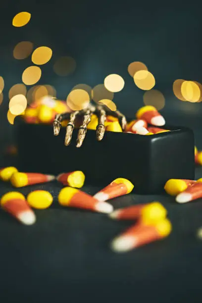 Photo of Coffin with skeleton hand and candy corn