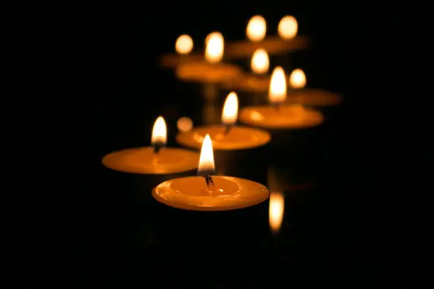 Photo of Candles in the dark with soft focus and bokehMemorial, hope
