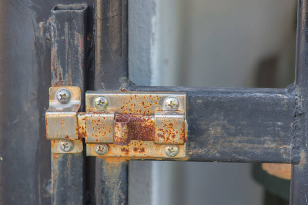 istock rusted key on gate in front of house 1050569812