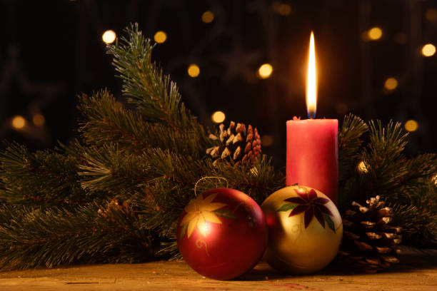 istock Christmas ball ornament with burning candle 1050570080