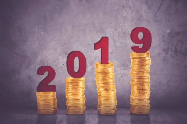 Image of piles of gold coins shaping growth chart with number 2019