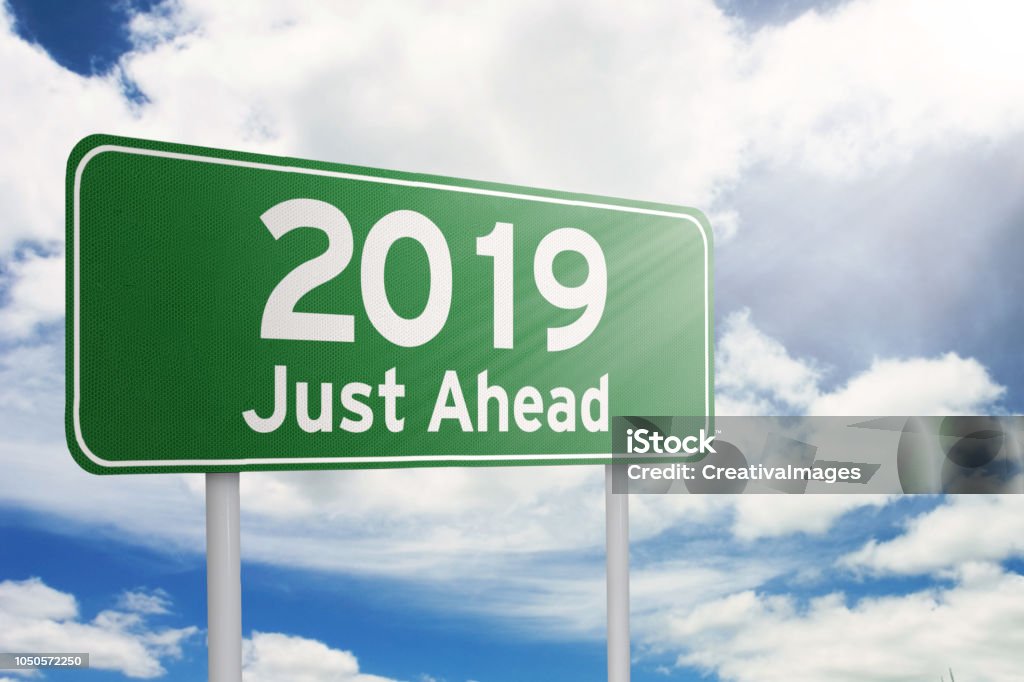 Signboard with a text of 2019 just ahead Image of a green signboard with a text of 2019 just ahead under sunlight 2019 Stock Photo