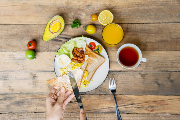 istock Unknown woman having delicious breakfast 1050572282