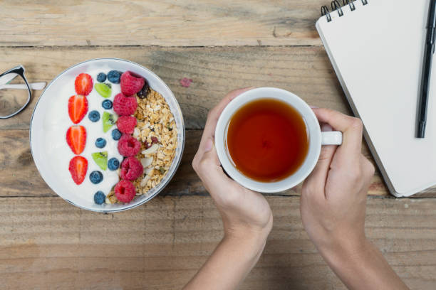 istock Young woman hands holding a cup of tea 1050572300