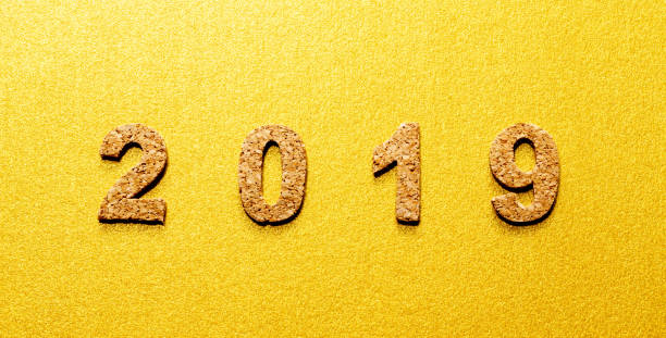 istock New years resolution 2019 concept. cork year number on gold color background with copy space 1050579906
