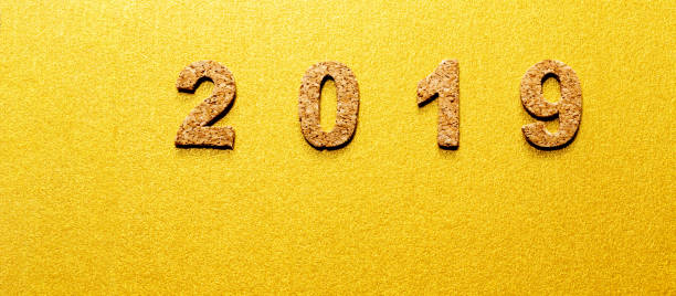 istock New years resolution 2019 concept. cork year number on gold color background with copy space 1050579964