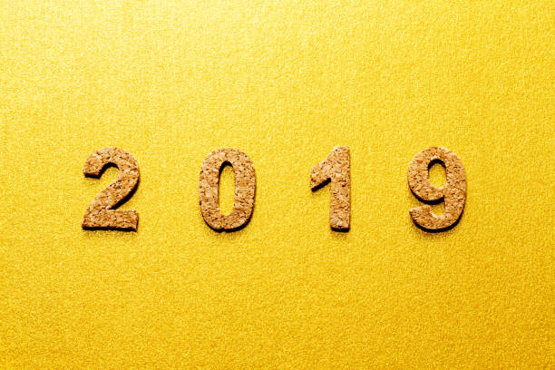 istock New years resolution 2019 concept. cork year number on gold color background with copy space 1050579976