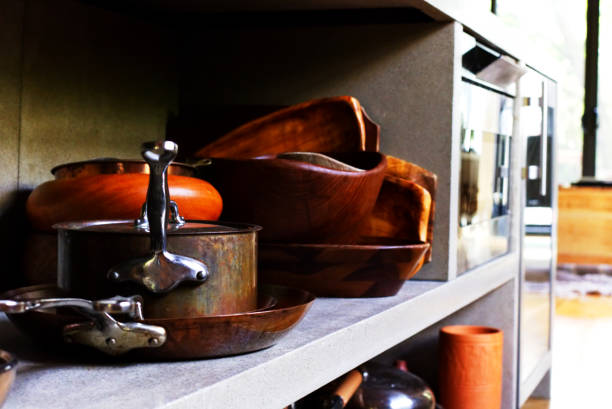 Pots and Pans A kitchen shelf filled with pots and pans. kitchen utensil antique toaster old stock pictures, royalty-free photos & images