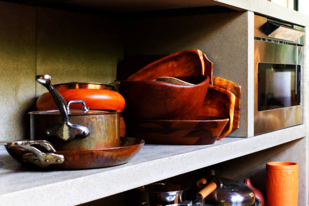 Pots and Pans A kitchen shelf filled with pots and pans. kitchen utensil antique toaster old stock pictures, royalty-free photos & images