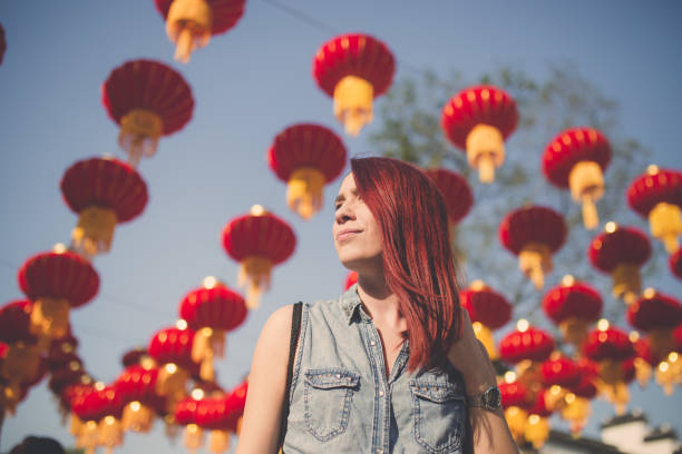 istock Beautiful Redhead And Chinese Lanterns In Sky 1050580268