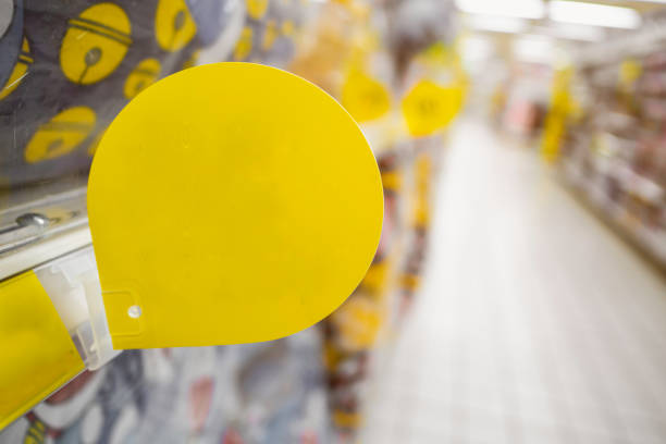 Mock up blank yellow discount tag on the products shelves in supermarket