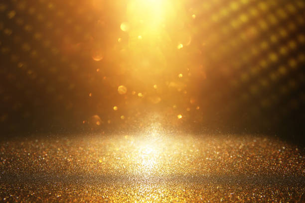 istock glitter vintage lights background. black and gold. de-focused. 1050594408
