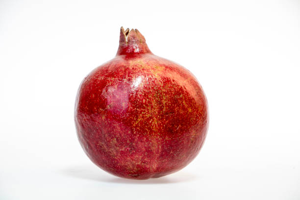 istock fresh and delicious pomegranate isolated on white background 1050600338
