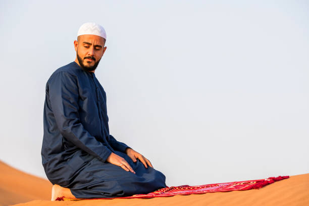 istock Arab man praying in the desert 1050603784