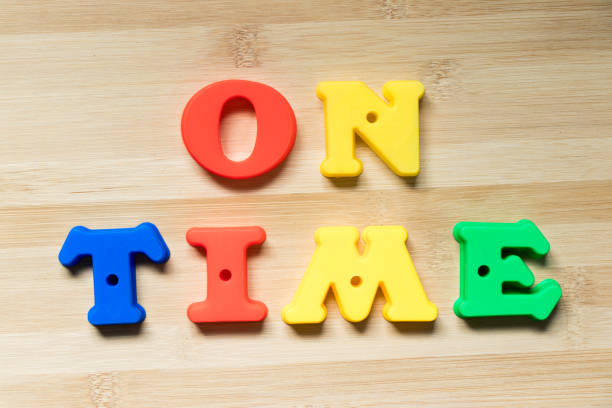 istock Color plastic alphabet in word on time on wood background 1050607444