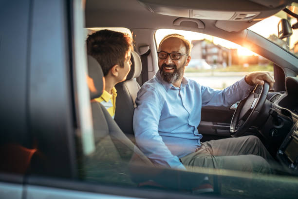 istock Father drives his son to school 1050613024