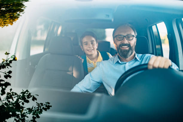 istock Dad drives his son in school 1050613236