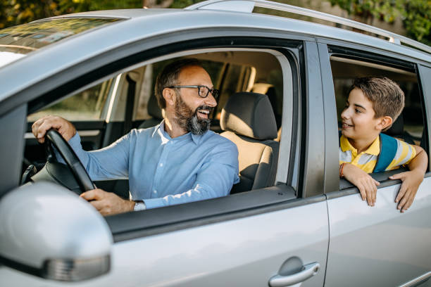 istock Dad drives his son in school 1050615802