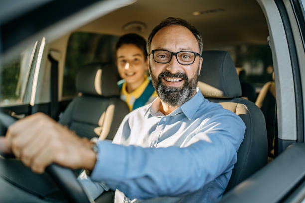istock Dad drives his son in school 1050615942
