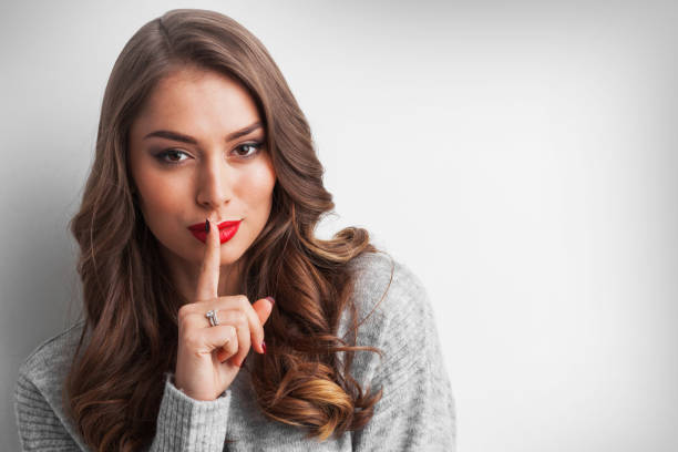 istock Woman with finger on lips 1050619006
