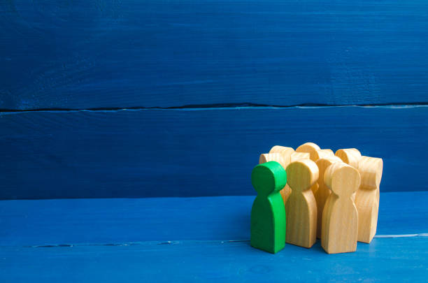 istock Crowd, meeting, social activity. Group people figurines. Society, social group. Herd instinct, management of people. Human resources, workers stand together. Green man stands out from group, 1050631064