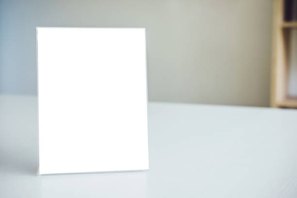 istock Mock up blank menu frame on table in modern workplace stand for your text of display your product 1050643318
