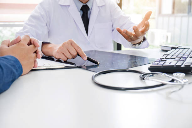 istock Professor doctor recommend report a method with patient treatment, results on examine a picture brain x-ray film about the problem of the patient with CT scan together with thoughtful method 1050643390