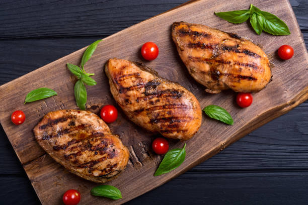 istock Grilled chicken breast ( fillet ) with basil and tomatoes 1050646478