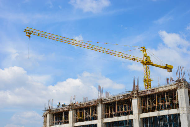 istock Building crane and building under construction against blue sky 1050647068