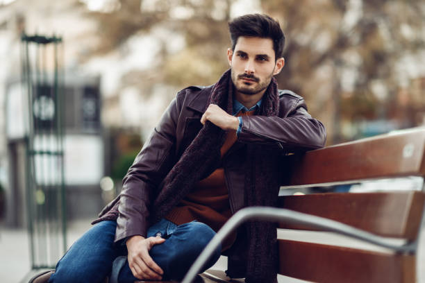istock Thoughtful young man sitting on an urban bench. 1050649600