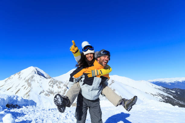 istock Young couple skiers having fun on top snow mountain 1050649616