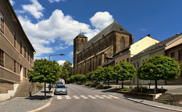 Turnov, Czech Republic, July 4, 2016: North Bohemian town Turnov and its Roman Catholic Church of the Nativity of Virgin Mary built between 1825 and 1853 as one of the first neo-gothic churches in Europe. A massive triple-walled building with an unspoiled tower has become the dominant feature of the city. Turnov lies in the heart of the Bohemian Paradise nature reserve which makes it a place for tourists and summer residents.