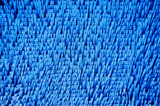 Background of a carpet covering of textiles in close-up of blue color.