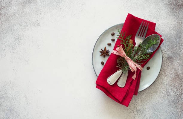 istock Chrismas table place setting. Tableware with evergreen twigs, cone and spice 1050656268