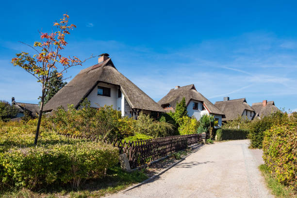 istock Thatched houses with blue sky in Ahrenshoop, Germany 1050656346
