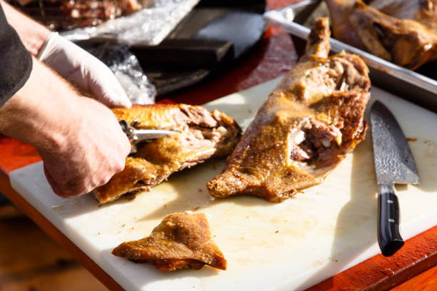 istock The cook cuts a fried duck or chicken with scissors 1050657198