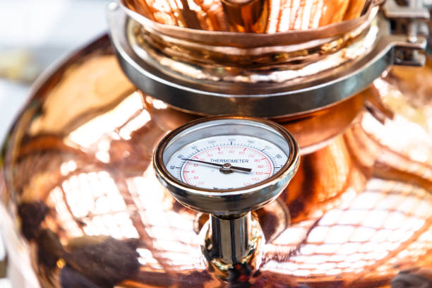 el termómetro en una olla de cobre para la destilación de alcohol - destilería fotografías e imágenes de stock