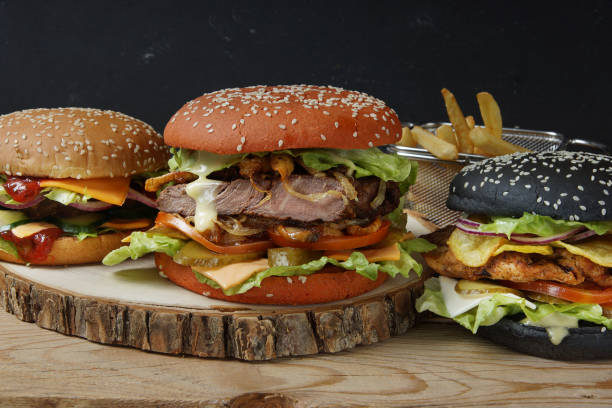 istock Three large beautiful burger with buns of different colors and different fillings, chicken, meat patty and steak 1050671578