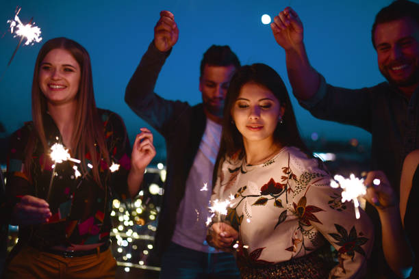 istock young people dancing with sparklers at blue night 1050674604