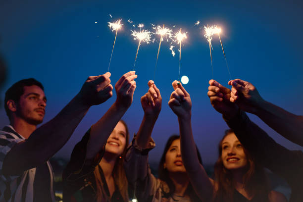 istock young people holding sparklers at blue night 1050674688