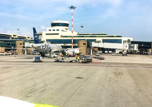 Ferno, Milan-Malpensa, Italy - April 28, 2018: Aircraft in preparation for the flight in Terminal 1 of Milan Malpensa International Airport.
