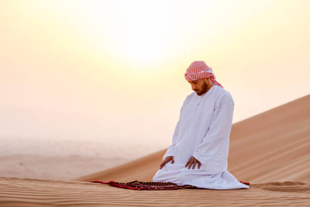 istock Arab man at the dunes praying to Allah 1050686278