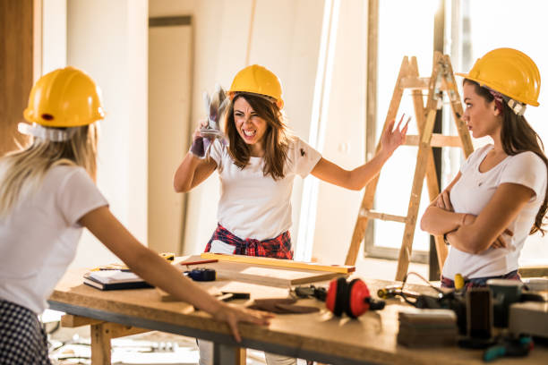 istock Frustrated female worker having problems with her coworkers at construction site. 1050688722
