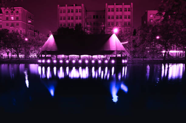 istock Night city cafe on river bank background 1050693618